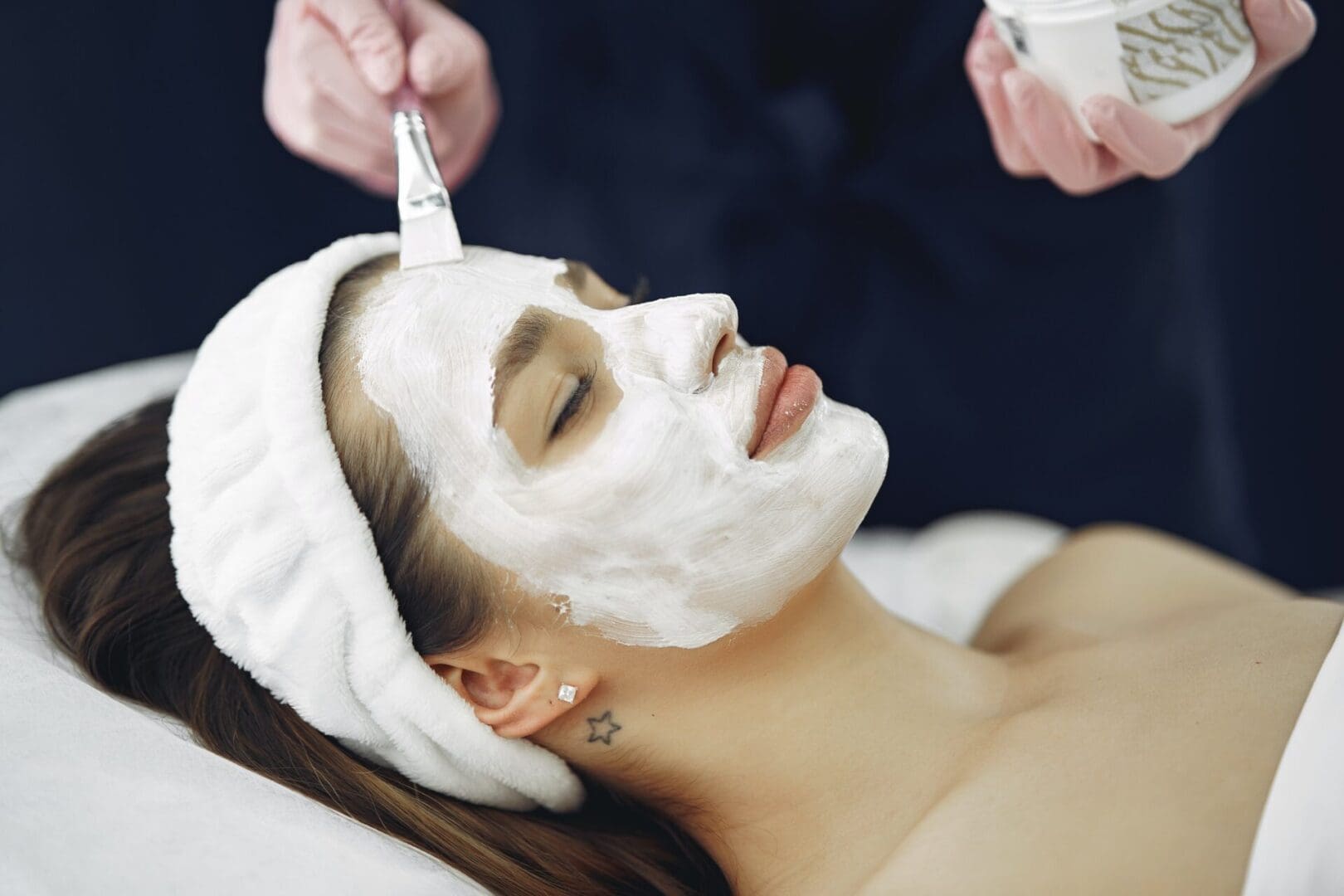 A facial mask being applied with a brush